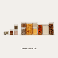 Starter set of tallow rectangle glass pantry jars filled with cereal, grains, and dried chili flakes, paired with four smaller spice jars next to them.