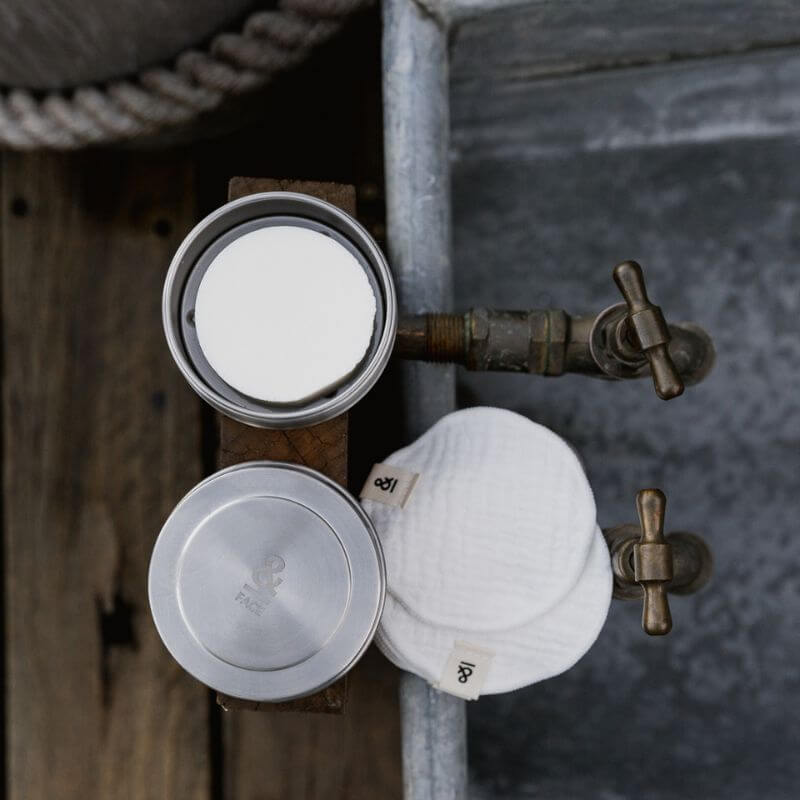three piece bar soap tin with a white round bar inside and next to some round make up wipes