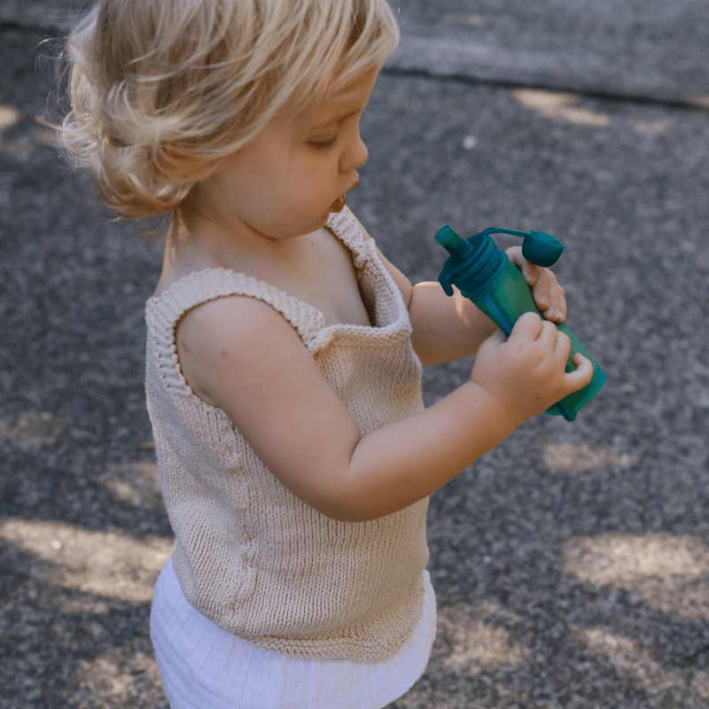 child eating from baby food pouch