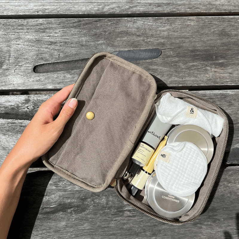 a olive green pouch with personal care items inside