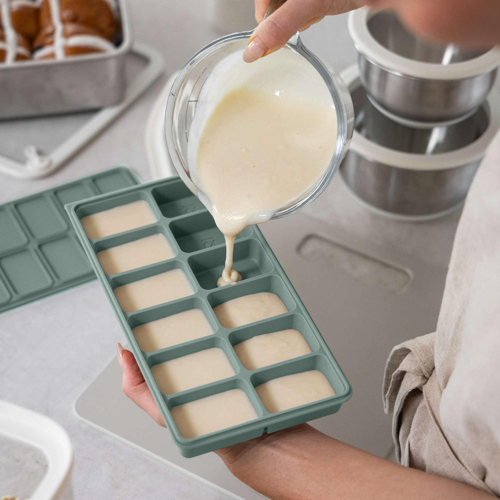 Parent pouring mix into a Seed & Sprout silicone freezer tray